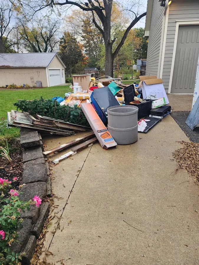 Dumpster being loaded with debris for Estate Cleanout Dumpster Rental in North Valley